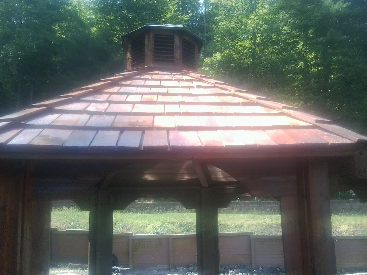 New cedar shake roof and cupola on a lakeside gazebo in Loretto